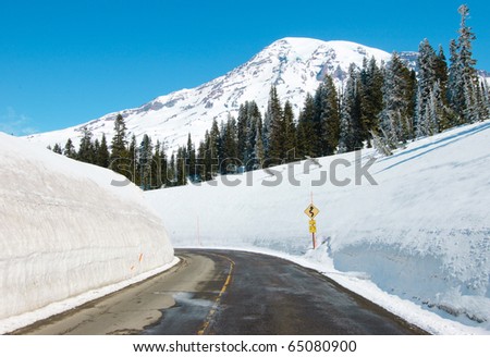 snow capped Mount Rainier and high walls of paved snow