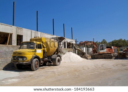 Yellow cement mixer truck and digger