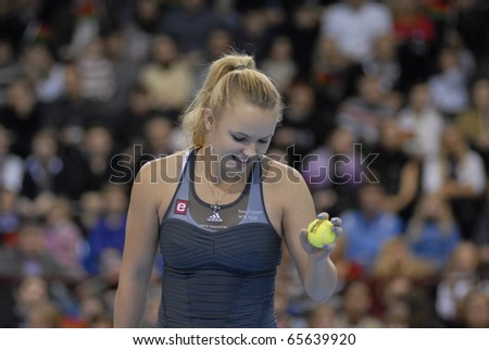 MINSK - NOVEMBER 19: Denmark\'s tennis star Caroline Wozniacki  gets ready to serve the ball during a charitable tennis match in Minsk, Belarus, on November 19, 2010