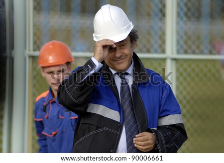 MINSK, BELARUS - OCTOBER 04: UEFA President Michel Platini(R) dons a hard hat during a construction work commencement of a building of the National Football Team Training Center on October 04, 2011 in Minsk, Belarus