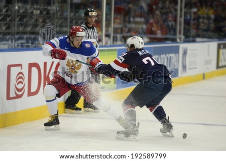 MINSK, BELARUS - MAY 12: Players battle for the puck during the IIHF World Championship match between Russia and USA at Minsk Arena on May 12, 2014 in Minsk, Belarus.