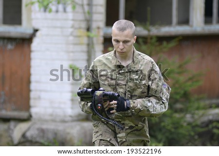 ZASLAWYE, BELARUS - MAY 17:  Player walk with gun during Laser Tag IT-CUP tournament at abandoned summer camp on May 17, 2014 in Zaslawye, Belarus.