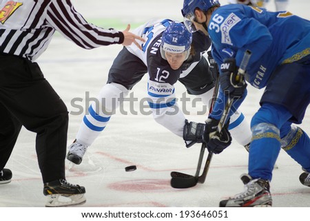 MINSK, BELARUS - MAY 19: JOKINEN Olli (12) of Finland and UPPER Dmitri (36) of Kazakhstan battle for the puck during 2014 IIHF World Ice Hockey Championship match on May 19, 2014 in Minsk, Belarus.