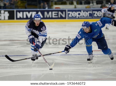 MINSK, BELARUS - MAY 19: HAULA Erik (56) of Finland and SEMYONOV Maxim (7) of Kazakhstan battle for the puck during 2014 IIHF World Ice Hockey Championship match on May 19, 2014 in Minsk, Belarus.