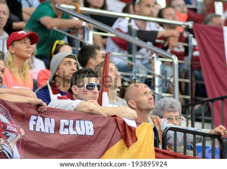 MINSK, BELARUS - MAY 20: Fans of Latvia looks dejected during 2014 IIHF World Ice Hockey Championship match on May 20, 2014 in Minsk, Belarus