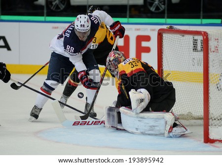 MINSK, BELARUS - MAY 20: MUELLER Peter of USA and AUS den BIRKEN Danny of Germany battle for the puck during 2014 IIHF World Ice Hockey Championship match on May 20, 2014 in Minsk, Belarus