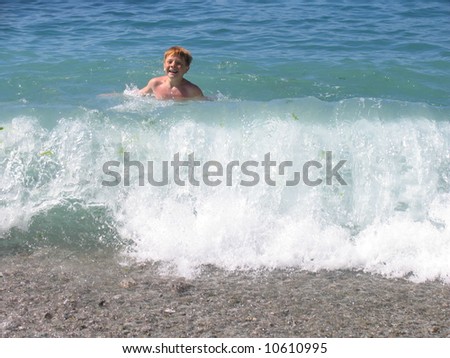 a boy swimming in  wave in the sea
