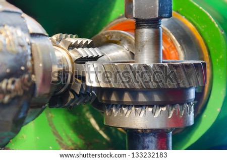 industrial machine for wormwheel gear and cogwheel production and service, rotating gears extreme closeup view