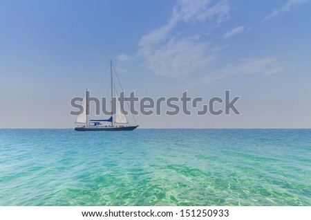 Seascape with sailboat the background of the blue sky.Beautiful sailboat sailing sail blue Mediterranean sea ocean horizon. Crystal clear water and summer sky