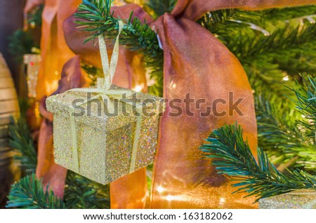 gold box christmas presents under the new year tree with ribbons