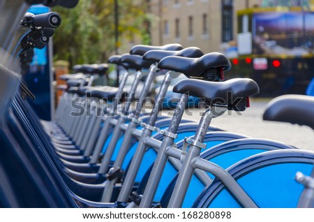 London Hire Bikes - Stock Image. A row of hire bikes lined up in a docking bay in London. Aiming to reduce traffic across the city and introduce an environmentally friendly form of transport.
