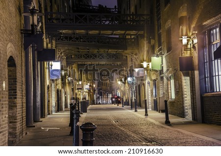 dark alley - Stock Image. London traditional old stone paved road at night, VINTAGE
