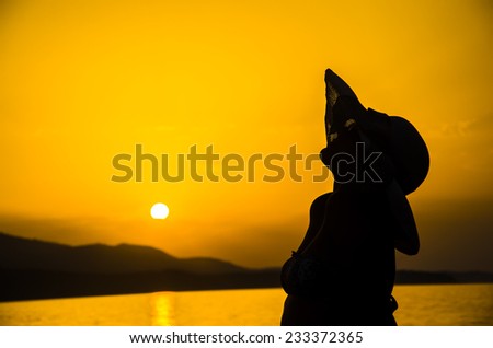A cowgirl with straw hat enjoy on sunset. Summer concept