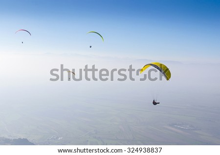 paragliding, parachuting, free gliding at blue sky