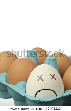 white eggs with sad face with brown eggs and white background