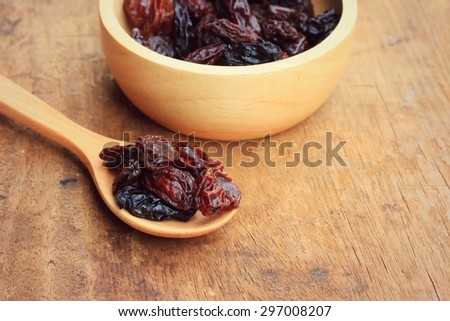 Heap of raisins on wood background vintage