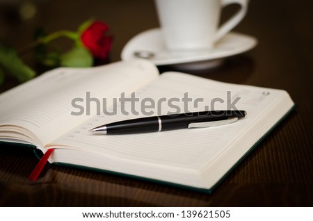 Agenda and pen in the front and a romantic rose and cup of coffee on the back with lots of style