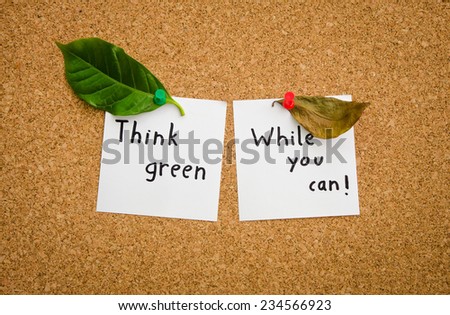 Think green while you can suggesting the ecologist green environmental movement and an important message for ecology everywhere with a dried up leaf and a green one