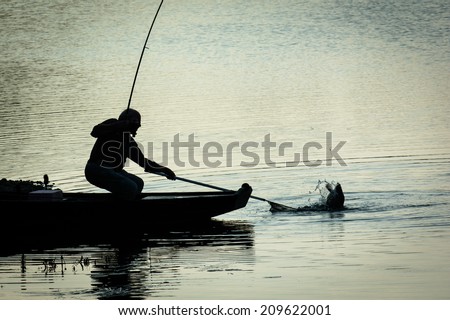 Fisherman Catching Fish on a Twilight Lake