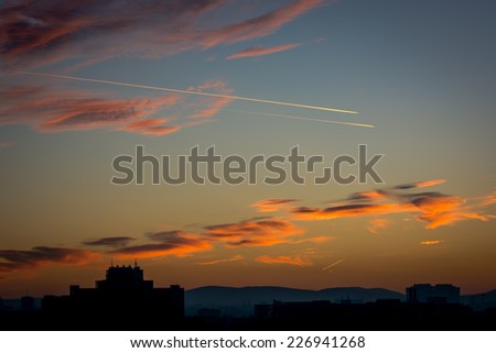 Cloudy Evening Sky With Airplanes And Skyline
