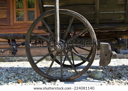 Part of ancient cart with wooden wheels.