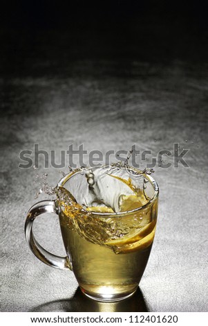 Lemon splash in cup of tea