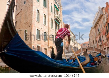 The gondolier floats on the channel of Venice