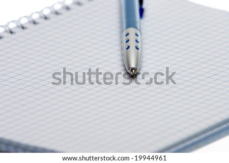Pen and paper on a white background