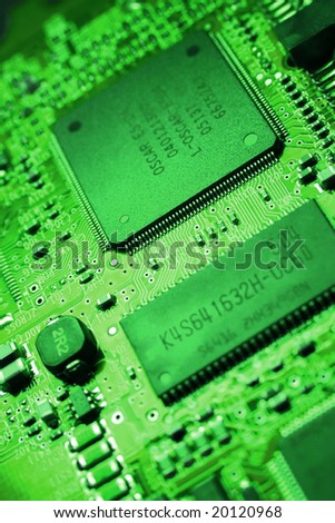 Fragment of the electronic circuit - green computer board with chips and components