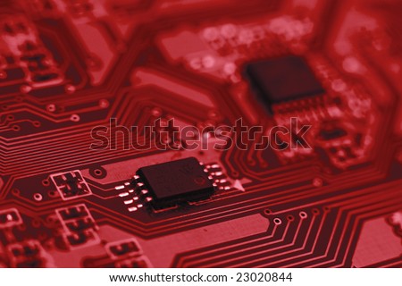 Fragment of the electronic circuit - red computer board with chips and components
