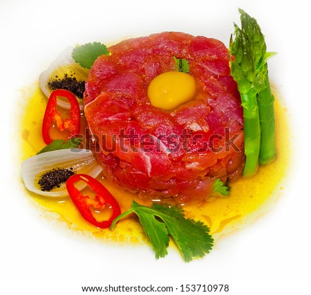 Served a dish of meat tuna with vegetables and raw egg