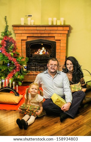 Friendly Family with a Christmas tree and a fireplace