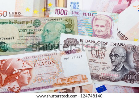 Bank note of the former Greek currency Drachma, the Italian Lire, the Portuguese Escudo and the Spanish pesetas on a background of Euro bank notes.