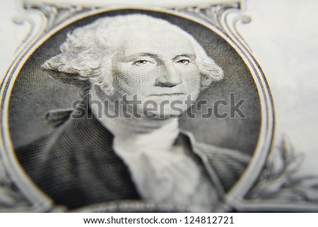 Very tight close-up on George Washington as printed on the one dollar bill, focus on the eyes.