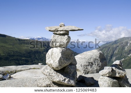 Arrow shaped marker made of stones, usable as business concept for guidance, pointing the way etc. Originally made for mountain hikers.