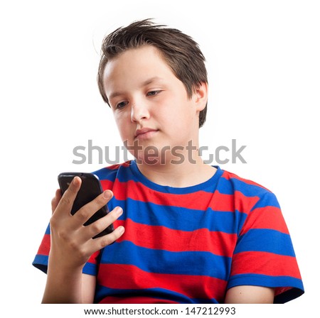 Teenage boy holding and looking at his mobile or smart phone