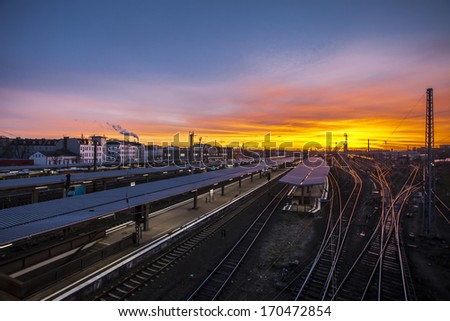 Train station for local and regional trains in Berlin Lichtenberg at sunset with colorful sky.