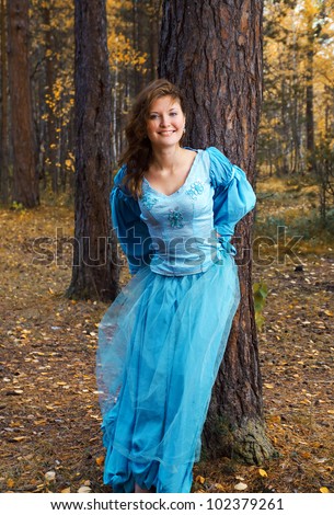 Very beautiful girl in medieval dress in autumn wood
