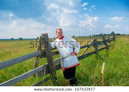 man  in national Russian clothes  in countryside