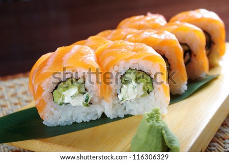 Uramaki. Philadelphia classic. Salmon, Philadelphia cheese, cucumber, avocado, tobiko. Japanese sushi