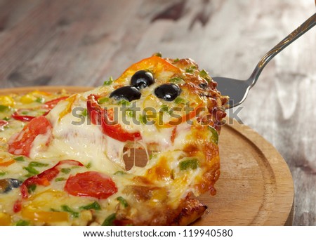 home pizza with tomato and eggplant  Closeup .taking slice of pizza,melted cheese dripping