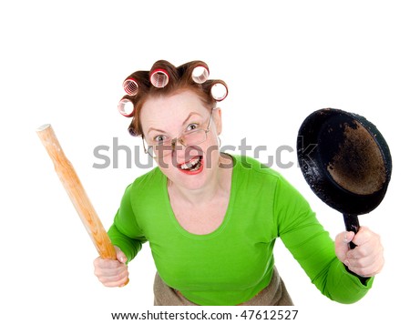 Angry crazy  housewife in hair rollers is holding.Angry look on face. Studio, white background.