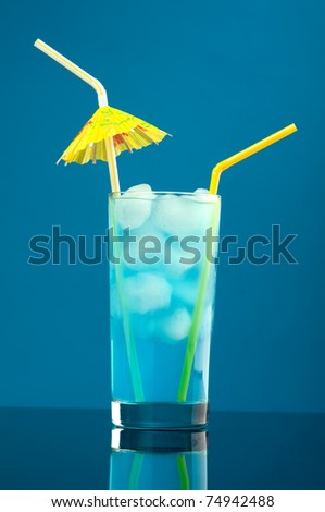 Blue hawaiian cold cocktail  closeup on blue background.