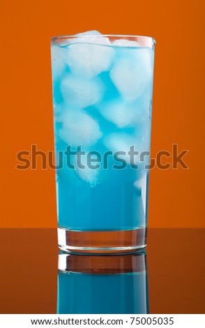 Blue hawaiian cold cocktail  closeup on yellow background