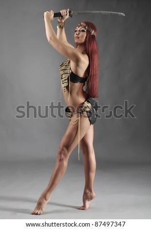 young warrior woman holding sword in her hand