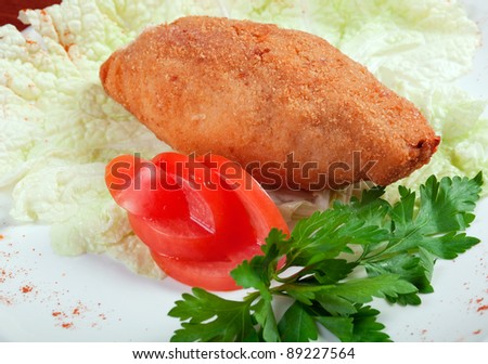 Italian cuisine.Chicken cutlets with parsley on white plate