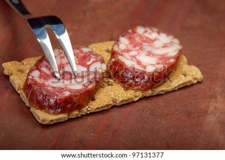 Salami and bread. close up with washed away by back background