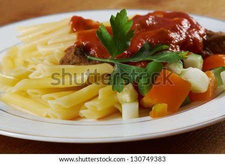 pasta with tomato beef sauce  on wooden table