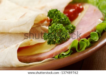 Pita Sandwich with cheese,ham,parsley,and tomato sauce