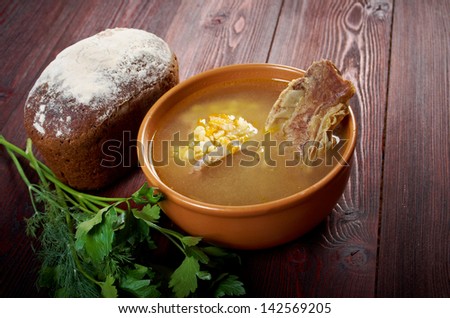 Pea soup with beef ribs  and farmhouse bread,edible greens .farmhouse kitchen